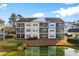 Exterior view of the condo building featuring private balconies and waterfront views from unit #301 at 611 Woodmoor Dr. # 301, Murrells Inlet, SC 29576