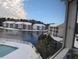 Scenic condo view overlooking the tranquil pond, fountain, and pool covered in snow at 611 Woodmoor Dr. # 301, Murrells Inlet, SC 29576