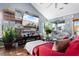 Bright living room with vaulted ceilings, wood floors, a red sofa, and a view to the outside at 611 Woodmoor Dr. # 301, Murrells Inlet, SC 29576