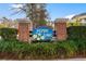 Charming entrance sign for Jasmine Lake community with lush landscaping and brick pillars at 611 Woodmoor Dr. # 301, Murrells Inlet, SC 29576