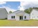 Lush backyard with view of the house and covered back porch at 620 Mccorkle Place, Conway, SC 29526