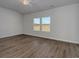 Bright bedroom featuring wood-look flooring and a large window with a scenic outdoor view at 620 Mccorkle Place, Conway, SC 29526