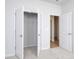 Bright bedroom with open closet and bathroom doorway, carpeted floors, and neutral walls at 620 Mccorkle Place, Conway, SC 29526