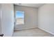 A bright, carpeted bedroom with a large window offers abundant natural light and neutral tones at 620 Mccorkle Place, Conway, SC 29526