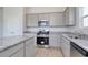 Modern kitchen featuring granite countertops, stainless steel appliances, and light gray cabinets at 620 Mccorkle Place, Conway, SC 29526