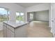 Modern kitchen with a granite island countertop that offers views of the living room and backyard pond at 620 Mccorkle Place, Conway, SC 29526