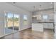 Bright kitchenette area with white cabinets, granite countertops, stainless steel appliances, and a sliding glass door at 620 Mccorkle Place, Conway, SC 29526