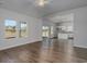 Open-concept living space with hardwood flooring, a ceiling fan, and large windows offering plenty of natural light at 620 Mccorkle Place, Conway, SC 29526