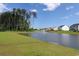 Pond view from the lawn with fountain and homes at 620 Mccorkle Place, Conway, SC 29526