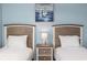 Close up of two twin beds with matching nightstand and lamps on blue walls at 6253 Catalina Dr. # 632, North Myrtle Beach, SC 29582