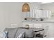 Cozy dining area with wooden table, white chairs, and stylish lighting, adjacent to a modern kitchen at 6253 Catalina Dr. # 632, North Myrtle Beach, SC 29582