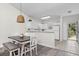 Inviting dining area with modern lighting, table and chairs, and access to the kitchen and entryway at 6253 Catalina Dr. # 632, North Myrtle Beach, SC 29582