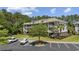 Exterior view of condominium with parking lot and manicured green spaces in a bright setting at 6253 Catalina Dr. # 632, North Myrtle Beach, SC 29582