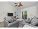 Bright living room featuring two sofas, a fan, and a sliding glass door leading to the outdoor patio at 6253 Catalina Dr. # 632, North Myrtle Beach, SC 29582