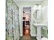 Bright bathroom showcasing pedestal sink and view through to the bedroom at 638 S Waccamaw Dr., Murrells Inlet, SC 29576