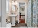 Well-lit bathroom featuring a pedestal sink and a decorative shower curtain at 638 S Waccamaw Dr., Murrells Inlet, SC 29576