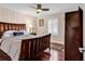 Cozy bedroom with hardwood floors, shutters, and a traditional-style bed frame at 638 S Waccamaw Dr., Murrells Inlet, SC 29576