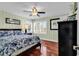 Charming bedroom featuring hardwood floors, ceiling fan, and shuttered windows at 638 S Waccamaw Dr., Murrells Inlet, SC 29576