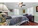 Comfortable bedroom featuring hardwood floors, windows with shutters, and a ceiling fan at 638 S Waccamaw Dr., Murrells Inlet, SC 29576