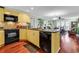 The kitchen features a corner sink with black appliances and flows into the dining room at 638 S Waccamaw Dr., Murrells Inlet, SC 29576