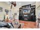 Cozy living room featuring a fireplace, TV, built in shelving and hardwood floors at 638 S Waccamaw Dr., Murrells Inlet, SC 29576