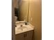 Well-lit bathroom with a white vanity, large mirror, and neutral wall color at 6500 Colonial Dr. # 2, Myrtle Beach, SC 29572