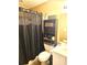 This bathroom features a toilet, shower curtain, and storage rack for ample storage at 6500 Colonial Dr. # 2, Myrtle Beach, SC 29572