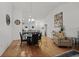 Bright dining room featuring a modern chandelier, hardwood floors, and seating for six at 725 Old Castle Loop, Myrtle Beach, SC 29579