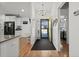 Hallway view featuring hardwood floors, a yellow front door, and an open kitchen and bedroom view at 725 Old Castle Loop, Myrtle Beach, SC 29579