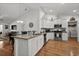 Open kitchen with white cabinets, stainless steel appliances, granite counters, and a dining area at 725 Old Castle Loop, Myrtle Beach, SC 29579