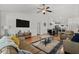 Open living room with wood floors, a large screen TV, and views to the dining room at 725 Old Castle Loop, Myrtle Beach, SC 29579