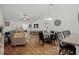 Open concept living space showcasing dining and living areas with hardwood floors and natural light at 725 Old Castle Loop, Myrtle Beach, SC 29579