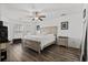 Bright and airy main bedroom featuring hardwood floors, a ceiling fan, and large windows at 725 Old Castle Loop, Myrtle Beach, SC 29579