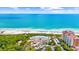 Aerial view of a beach complex, showcasing the pristine beach, large pool, and well-maintained landscape at 7322 Sarteano Dr., Myrtle Beach, SC 29572