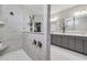 Contemporary bathroom featuring marble shower, vanity with marble countertop, and stylish mirrors at 7322 Sarteano Dr., Myrtle Beach, SC 29572