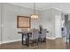 Dining area with a wooden table, upholstered chairs, and modern chandelier at 7322 Sarteano Dr., Myrtle Beach, SC 29572