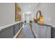 Gray paneled hallway with console table featuring decorative mirror and lamps at 7322 Sarteano Dr., Myrtle Beach, SC 29572