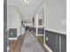 Inviting gray hallway with elegant wainscoting, wood floors, leading to bright living area at 7322 Sarteano Dr., Myrtle Beach, SC 29572