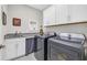 Functional laundry room with a sink, modern washer and dryer, and plenty of storage space at 7322 Sarteano Dr., Myrtle Beach, SC 29572