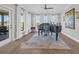 Bright living room with piano, neutral colors, large windows, and elegant white draperies at 7322 Sarteano Dr., Myrtle Beach, SC 29572