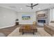 Cozy living room with stone fireplace, mounted TV, wood floors, and comfortable seating at 7322 Sarteano Dr., Myrtle Beach, SC 29572