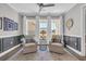 Sitting room featuring two chairs, wainscoting, and a three-panel window for ample natural light at 7322 Sarteano Dr., Myrtle Beach, SC 29572