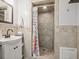 Bathroom with tiled shower, vanity sink and neutral colored walls at 7609 Driftwood Dr., Myrtle Beach, SC 29572