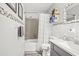 Tidy bathroom with a single sink vanity, a white shower curtain, and modern tile accents at 7609 Driftwood Dr., Myrtle Beach, SC 29572