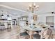 Open floor plan with a dining area featuring hardwood floors and modern chandelier at 7609 Driftwood Dr., Myrtle Beach, SC 29572