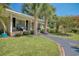 Lovely home exterior with palm trees, a covered porch, and a walkway surrounded by lush greenery at 7609 Driftwood Dr., Myrtle Beach, SC 29572