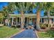 Inviting home exterior with palm trees, brick accents, a quaint porch, and a well-manicured lawn at 7609 Driftwood Dr., Myrtle Beach, SC 29572