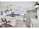 Bright kitchen with white cabinets, stainless steel appliances, granite countertops, and a blue mosaic backsplash at 7609 Driftwood Dr., Myrtle Beach, SC 29572