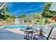 Inviting outdoor space featuring a refreshing pool with a table and chairs under the bright blue sky at 7609 Driftwood Dr., Myrtle Beach, SC 29572