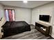 Bedroom featuring vinyl floors, a black bedspread and a wall-mounted TV at 801 Burcale Rd. # G-5, Myrtle Beach, SC 29579